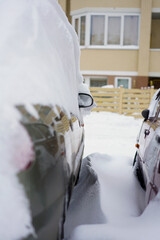 After the snowfall, glass and car mirror in the snow