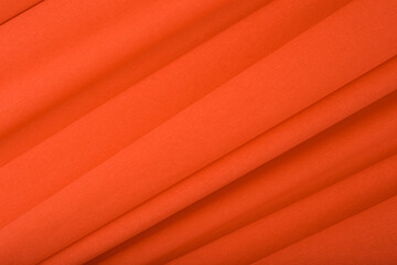 Abstract orange background with diagonal lines. Orange textured background with waves made of...