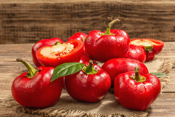 Ripe red round peppers on a vintage sackcloth napkin