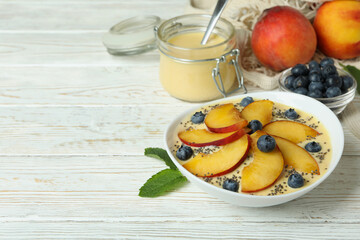 Concept of healthy food with peach yogurt on white wooden table