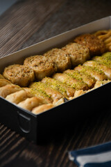 Close Up Turkish Baklava sweet pastry with honey in box. Food Background