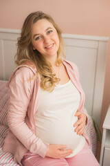 Young attractive pregnant woman on the sofa - 457095955