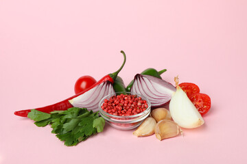 Different spicy vegetables on pink background, close up