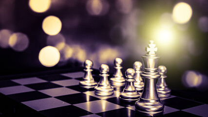 Closeup of chess characters on board games. to represent decision making in term of business strategy to find out the best solution to meet target objective and goal.