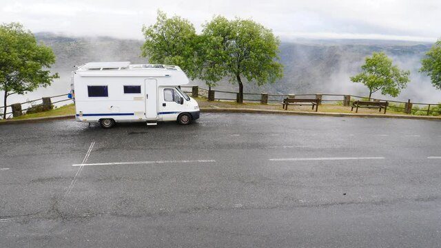 Caravan camping in mountains at Penedo Durao lookout in north Portugal. Rainy cloudy weather. Traveling by motorhome. Place to visit.