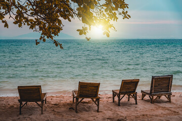Nature in twilight period which including of sunrise over the sea and the nice beach. Summer beach with blue water and purple sky at the sunset.	
