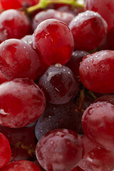 Red ripe grape with water drops all over background