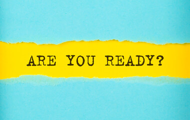 ARE YOU READY text on the torn paper , yellow background