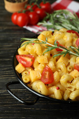 Concept of tasty eating with macaroni with cheese on wooden background