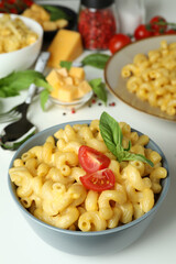 Concept of tasty eating with macaroni with cheese on white background