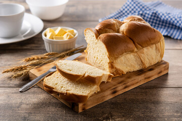 Braided egg bread on wooden table	