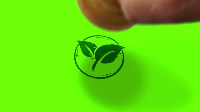 Green leaf eco friendly symbol stamp and hand stamping impact isolated animation. Co2 neutral, ecology, environment, nature and climate 3D rendered concept. Alpha matte channel.