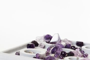 Beautiful purple natural gemstone amethyst on a white background.