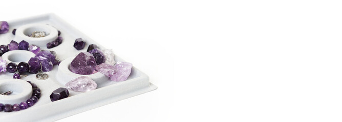 Beautiful purple natural gemstone amethyst on a white background.
