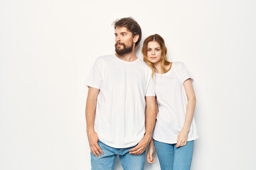 Fototapeta premium cheerful young couple in white t-shirts friendship lifestyle light background