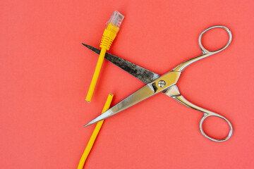 Yellow internet cord cut by scissors