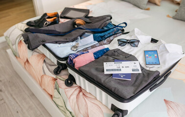Businessman suitcase prepared for business trip with boarding pass