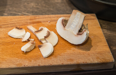 Half mushrooms and pieces on a cutting board