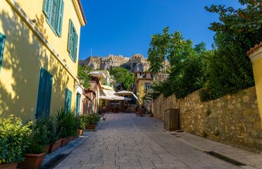 Athens street with yellow house, with the acropolis at the end above the mount