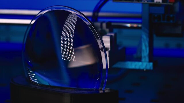 Test of a plastic lens for an optical device using a laser in an optics laboratory