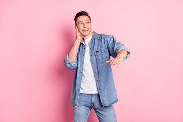 Fototapeta premium Portrait of attractive cheerful guy dancing having fun showing height isolated over pink pastel color background