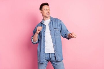 Portrait of attractive cheerful guy dancing having fun clubbing free time isolated over pink pastel color background