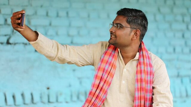 Technology concept : Indian farmer using smartphone