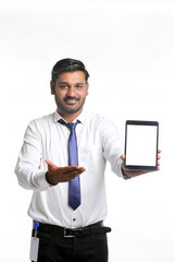 Young indian officer showing tablet screen on white background.