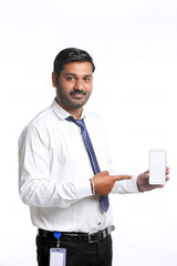 Young indian officer showing smartphone screen on white background.