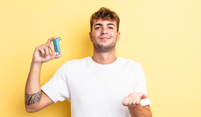 young handsome man smiling happily with friendly and  offering and showing a concept. asthma concept