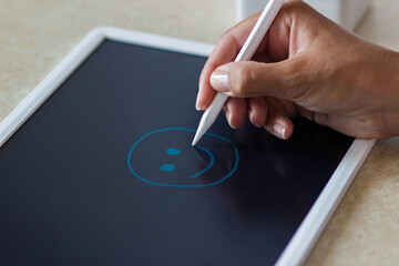 Woman drawing with a tablet device
