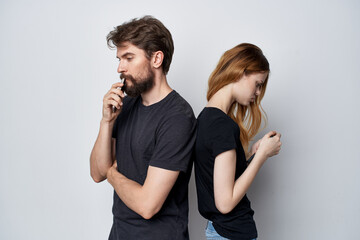 family in black t-shirts phone fun together friendship light background