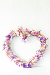 Colorful heart shaped flower arrangement with white background