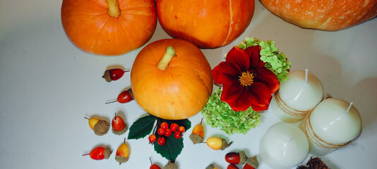 Preparing for Halloween. Pumpkins on the table with orange acorns and candles