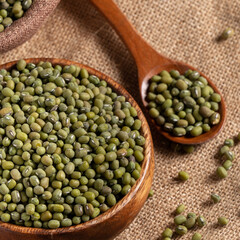 Close up of raw mung bean on wooden table background.