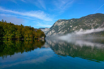 Fototapeta na wymiar Picturesque mountain lake in a foggy morning.