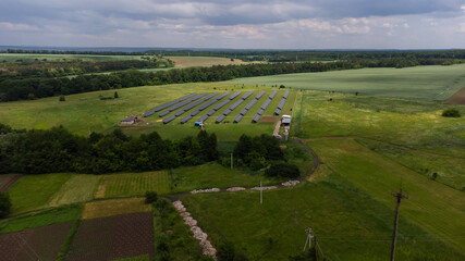 Aerial view of Solar Panels Farm solar cell with sunlight. Drone flight over solar panels field, renewable green alternative energy concept.