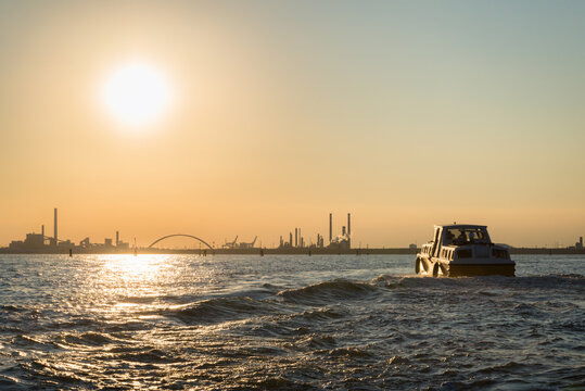 Sahara sand contamined sunset at industrial zone of Venice - Marghera with Vaporetto in foreground