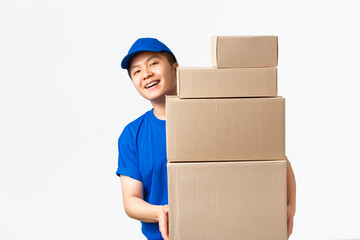 Online shopping, fast shipping concept. Smiling happy asian delivery man in blue courier uniform,...