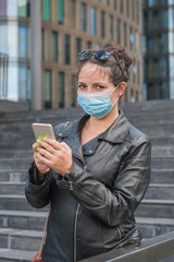 Beautiful woman wearing medical mask with mobile phone