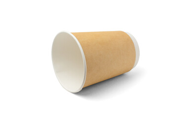Empty paper, disposable cup for hot drinks lying on its side. Isolated on a white background with a shadow.