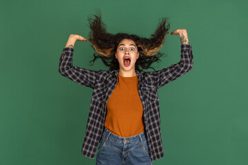 Portrait of Latino beautiful girl isolated on green, vintage color studio background. Concept of human emotions, facial expression, natural beauty, diversity