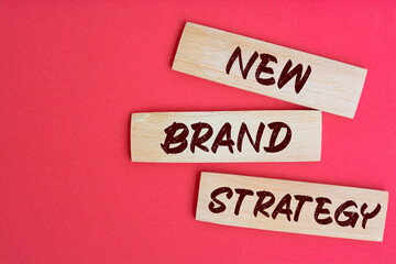 New Brand Strategy Text on Wooden Blocks on red Background