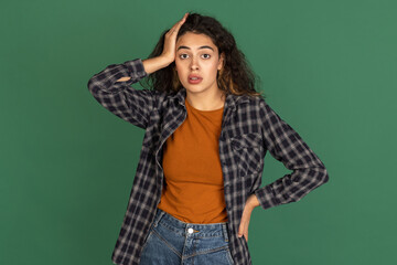 Portrait of Latino beautiful girl isolated on green, vintage color studio background. Concept of human emotions, facial expression, natural beauty, diversity