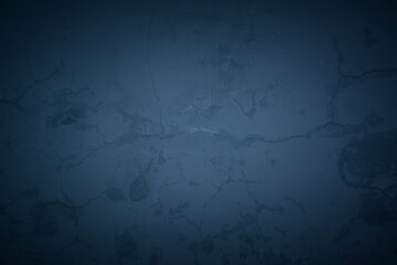 Old blue wall in spots, cracks, stains. Painted concrete wall in abstract grunge style loft. Vintage wall background texture for backgrounds, portraits, posters.