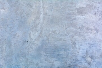 Old white wall in spots, cracks, stains. Painted concrete wall in abstract grunge style loft. Vintage wall background texture for backgrounds, portraits, posters.