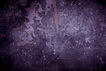 Old purple wall in spots, cracks, stains. Painted concrete wall in abstract grunge style loft. Vintage wall background texture for backgrounds, portraits, posters.