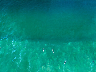 Surfers relaxing at the back line of the calm swell in Cape Town, South Africa  