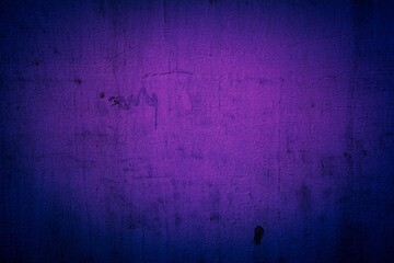 Old purple wall in spots, cracks, stains. Painted concrete wall in abstract grunge style loft. Vintage wall background texture for backgrounds, portraits, posters.