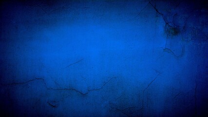 Old blue wall in spots, cracks, stains. Painted concrete wall in abstract grunge style loft. Vintage wall background texture for backgrounds, portraits, posters.